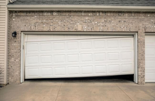 Damaged and misaligned garage door requiring urgent garage door repair in Sydney by Garage Door Guys Sydney.