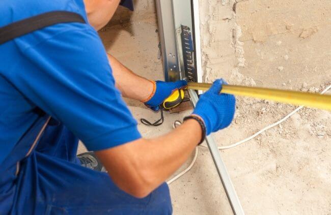 Garage Door Guys Sydney carrying out precise garage door opener installation in Sydney with accurate bracket measuring.