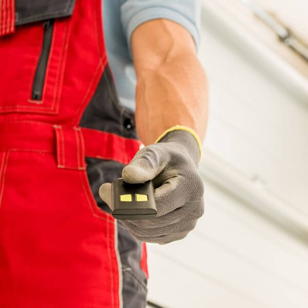 Garage Door Guys Sydney technician testing a garage door remote control for smooth operation.