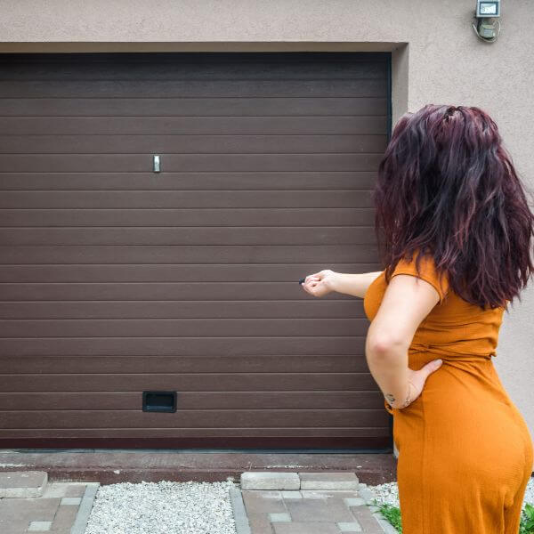 Garage door remote replacement in Sydney with a customer checking operation serviced by Garage Door Guys Sydney.