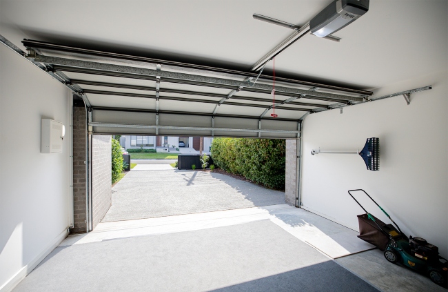 Merlin garage motor is installed on a panel lift door system in a residential garage.